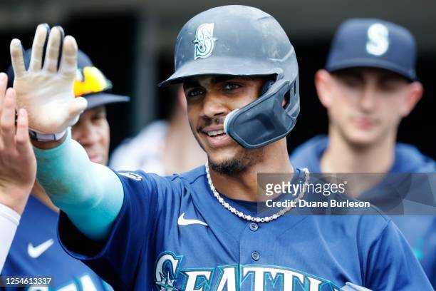 Julio Rodriguez of the Seattle Mariners celebrates after scoring against the Detroit Tigers on a single hit by Teoscar Hernandez during the ninth...
