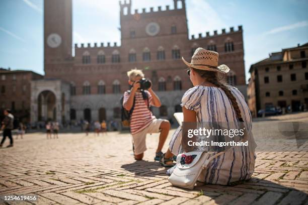 brother and sister sightseeing siena, italy - modern town square stock pictures, royalty-free photos & images