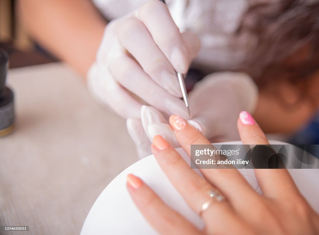 Painting on manicure. Beauty procedure