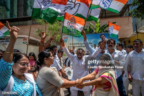 Congress workers celebrate victory as the party sweeps Karnataka assembly elections, outside Tilak Bhavan, Dadar, on May 13, 2023 in Mumbai, India....