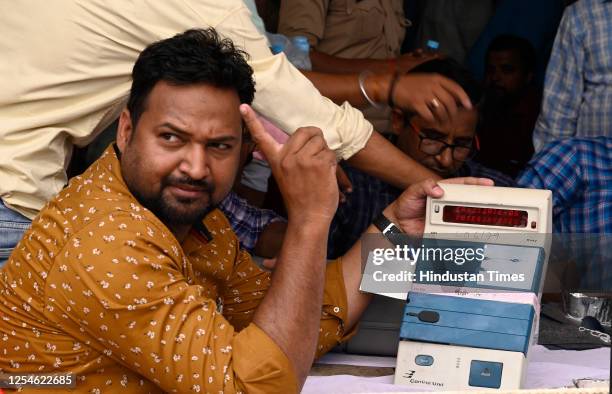 Election staff members open an electronic voting machine to count votes for the result of Local bodies' election inside a vote counting center at...