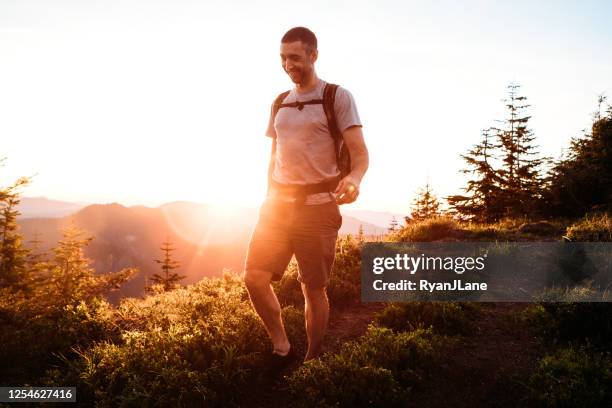 man hiking in pacific northwest mountains at sunset - hiking pacific northwest stock pictures, royalty-free photos & images