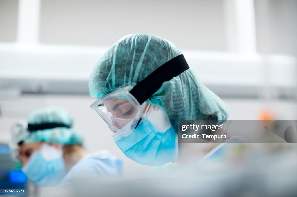 Healthcare worker wearing protective mask and glasses in a  Hospital COVID ward.