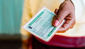 Woman holds the Voter License (Título Eleitoral). It is a document that proves that the person is able to vote in Brazil elections.