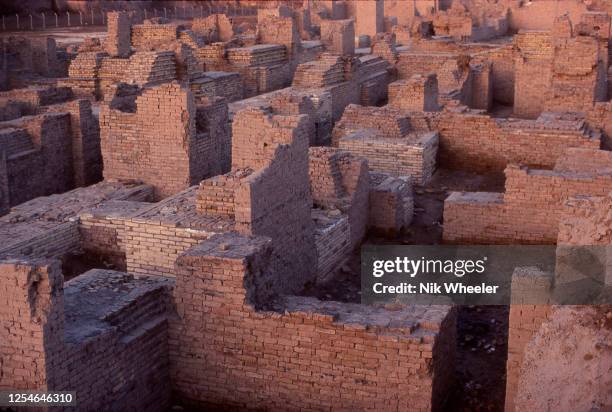 The broken mud brick walls of the archaeological site of Babylon, capital of the ancient kingdom of Babylonia built between the 18th and 6th...