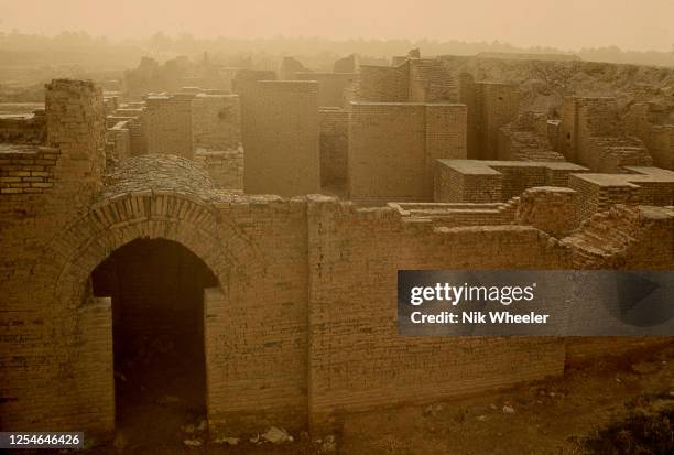 The broken mud brick walls of the archaeological site of Babylon, capital of the ancient kingdom of Babylonia built between the 18th and 6th...