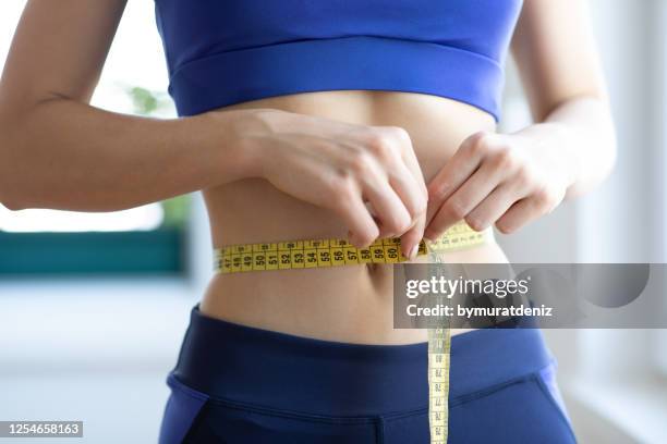 the proof is in the inches - flat stomach stock pictures, royalty-free photos & images