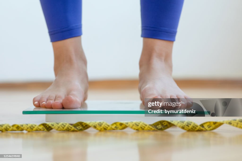 Female feet on weighing scale