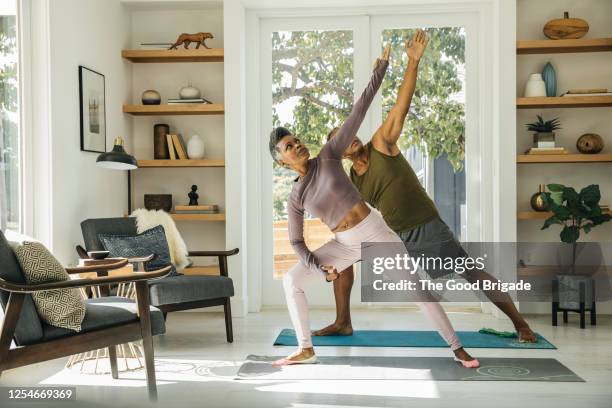 mature couple practicing yoga at home - senior yoga lady stock pictures, royalty-free photos & images