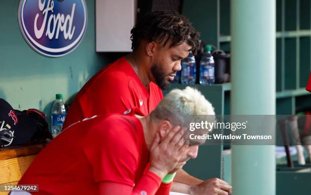 As Enrique Hernandez of the Boston Red Sox holds his head in his hands, pitcher Kenley Jansen hangs his head after hiving up three runs to the St....