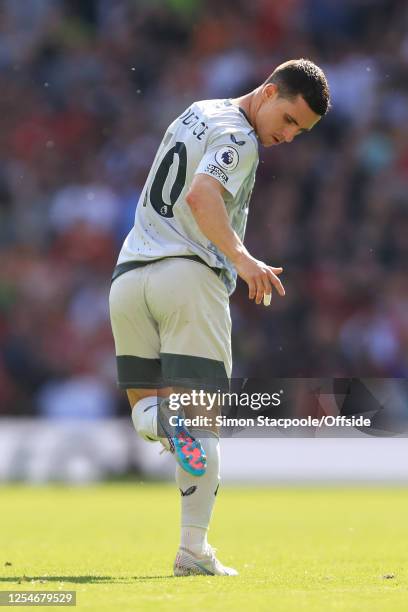 Daniel Podence of Wolverhampton Wanderers checks the studs on the bottom of his boots during the Premier League match between Manchester United and...