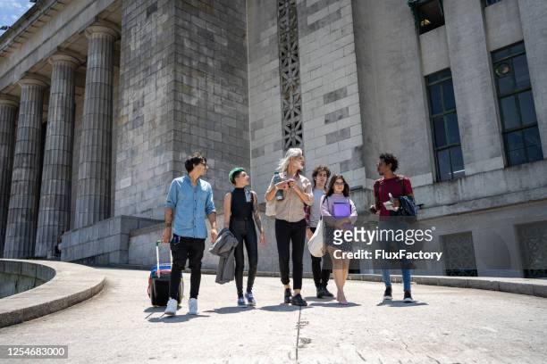 traveling student and a professor enjoying a sunny day together - campus tour stock pictures, royalty-free photos & images