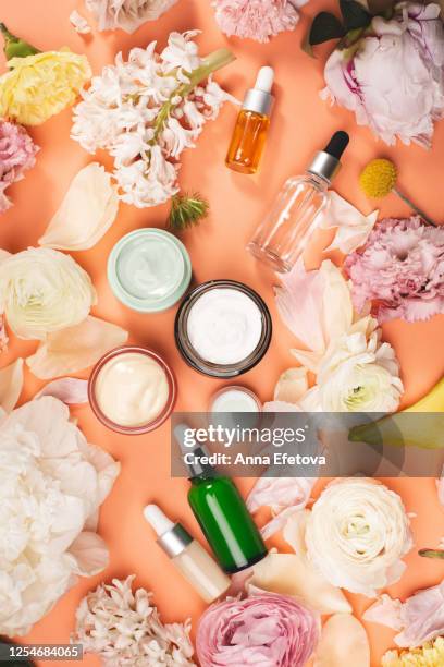 assorted flowers around natural cosmetics - skin care ingredients stock pictures, royalty-free photos & images