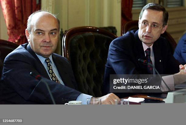 New Argentine Economy Minister Domingo Cavallo and Chancellor Adalberto Rodriguez Giavarini, listen to Employment Minister Patricia Bullrich 22 March...