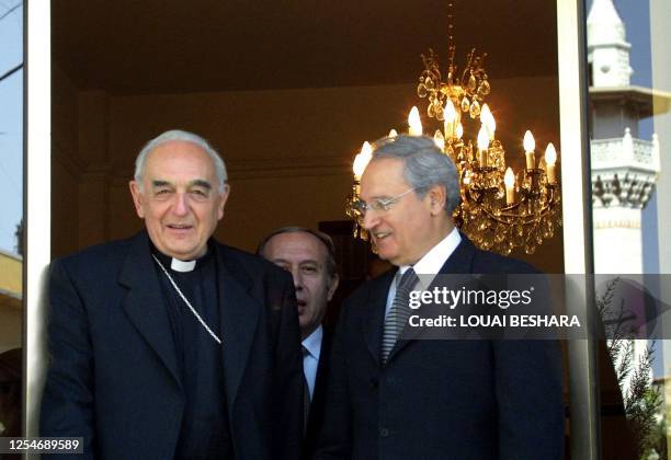 Syrian Foregn Minister Faruq al-Shara walks out with Vatican envoy Cardinal Roberto Tucci after their meeting in Damascus 17 March 2001 to discuss...