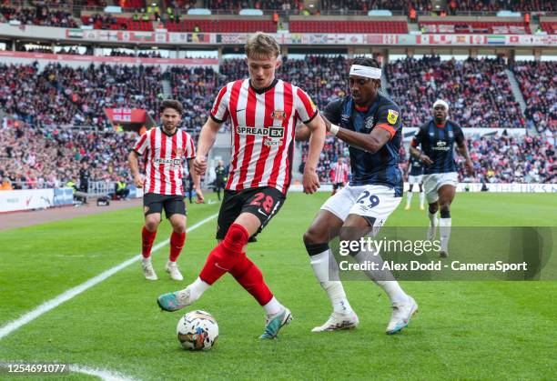 Sunderland's Joe Gelhardt shields the ball from Luton Town's Amari'i Bell during the Sky Bet Championship Play-Off Semi-Final First Leg match between...