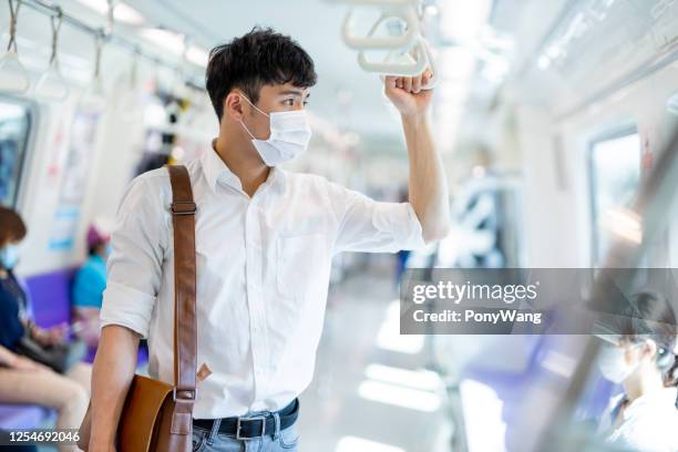 man with mask in metro - taipei mrt stock pictures, royalty-free photos & images