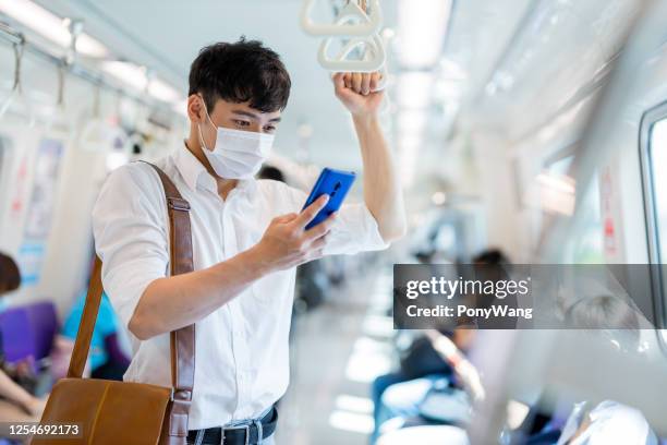 man with mask in metro - taipei mrt stock pictures, royalty-free photos & images