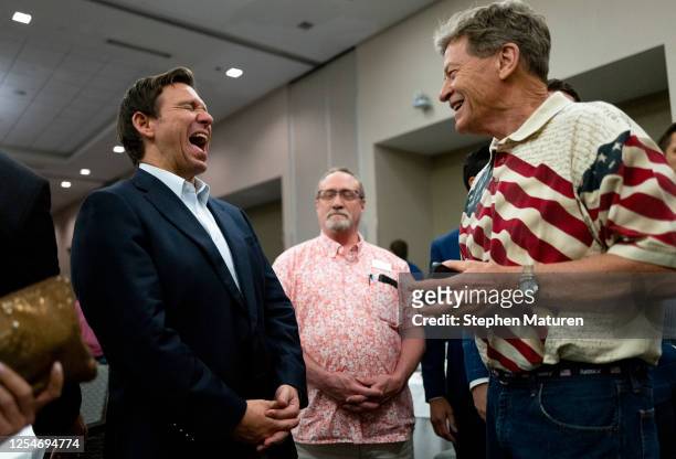 Florida Gov. Ron DeSantis speaks with attendees during an Iowa GOP reception on May 13, 2023 in Cedar Rapids, Iowa. Although he has not yet announced...