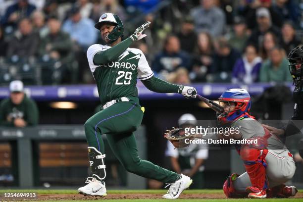 Jurickson Profar of the Colorado Rockies hits a third inning double in a game against the Philadelphia Phillies at Coors Field on May 13, 2023 in...