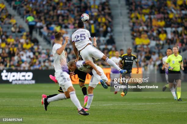 Orlando City defender Antonio Carlos goes up over Orlando City defender Robin Jansson for a goal kick during the first half in a game against the...