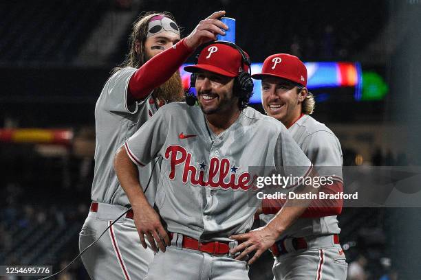 Brandon Marsh and Bryson Stott place a cup on the head of Garrett Stubbs of the Philadelphia Phillies as Stubs gives a post game interview after a...