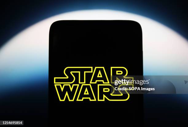 In this photo illustration, a Star Wars logo is seen on a smartphone screen.