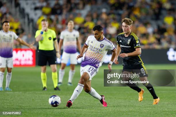 Orlando City midfielder Martín Ojeda keeps the ball from Columbus Crew midfielder Aidan Morris during the second half in a game on May 13 at...