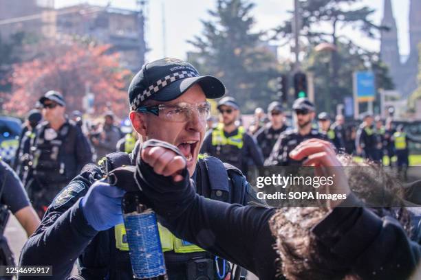 Police officer shouts get back as he deploys his crowd control spray on an anti-fascist protester during the demonstration. A day of political...