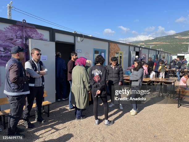 Earthquake survivor voters arrive at the container polling station to cast their ballots for presidential and parliamentary elections Nurdagi...