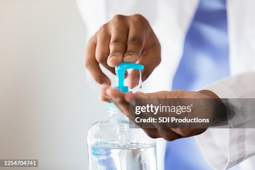 Female doctor uses hand santizer Female doctor uses hand santizer