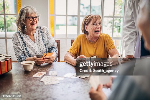 Senior women playing cards and having fun in nursing home Senior women playing cards and having fun in nursing home