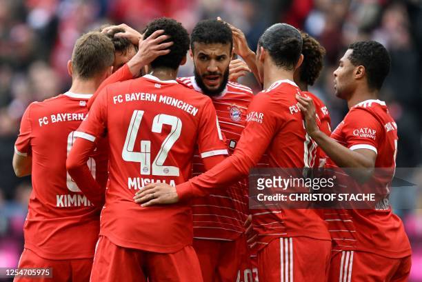Teammates celebrate with Bayern Munich's Moroccan defender Noussair Mazraoui after the first goal for Munich during the German first division...