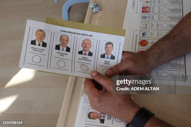 Person holds a ballot at a polling station in Ankara on May 14 for parliamentary and presidental elections in Turkey. Turkey is voting in a momentous...