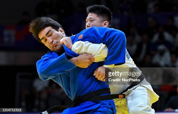 Alisher Yusupov of Uzbekistan and Kokoro Kageura of Japan compete during the men's +100kg bronze medal match of the World Judo Championships 2023 in...