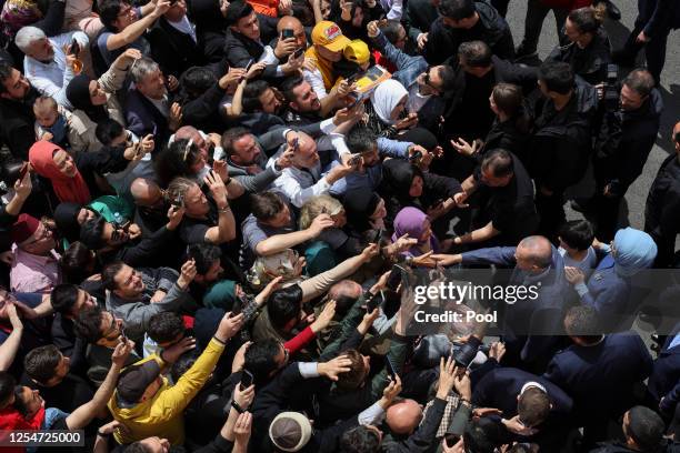 Turkish President Tayyip Erdogan and his wife Emine Erdogan meet supporters outside a polling station in the Uskudar district after casting their...