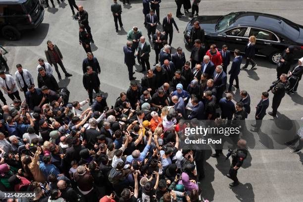 Turkish President Tayyip Erdogan and his wife Emine Erdogan greet supporters during Turkey's general election at a polling station in the Uskudar...