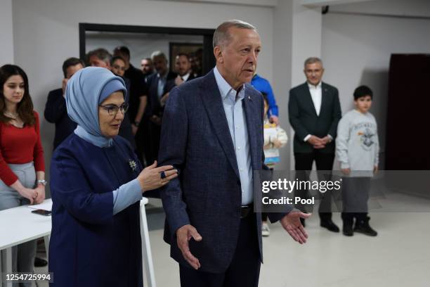 Turkish President Recep Tayyip Erdogan and his wife Emine Erdogan arrive to cast their vote in Turkey's general election at a polling station in the...