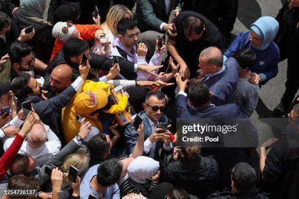 Turkish President Tayyip Erdogan and his wife Emine Erdogan greet supporters during Turkey's general election at a polling station in the Uskudar...