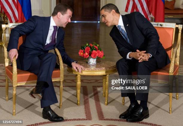 President Barack Obama speaks with Russian President Dmitry Medvedev during a meeting at the Winfield House, the US Ambassador's residence in London,...