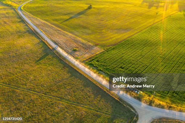 country road, aerial view - farm australia stock pictures, royalty-free photos & images