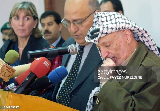 Palestinian Authority President Yasser Arafat, listens to a question by the press as Luxembourg's Foreign Minister Lydie Polfer looks on during a...