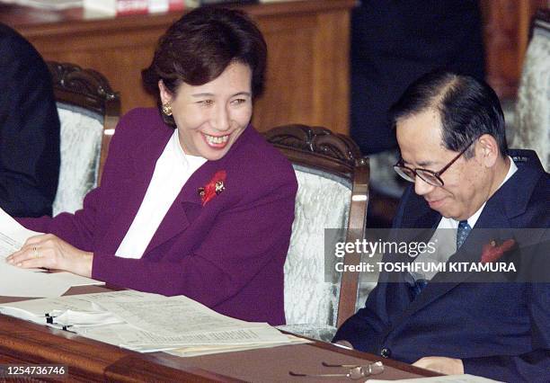 Japanese Foreign Minister Makiko Tanaka shares a smile with Chief Cabinet Secretary Yasuo Fukuda as they react to questions by opposition Democratic...