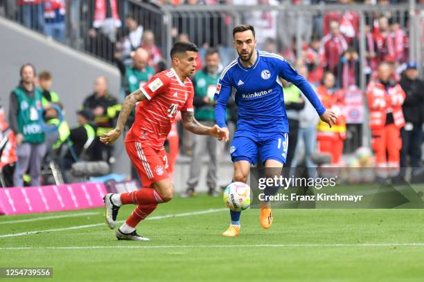 Joao Cancelo of Bayern Muenchen and Kenan Karaman of FC Schalke 04 during the Bundesliga match between FC Bayern Muenchen and FC Schalke 04 at...