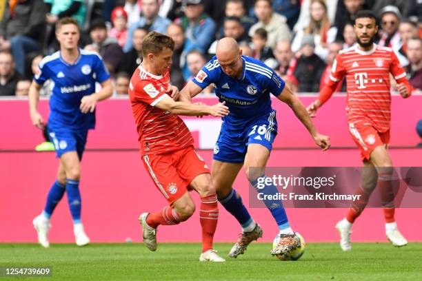 Joshua Kimmich of Bayern Muenchen and Michael Frey of FC Schalke 04 during the Bundesliga match between FC Bayern Muenchen and FC Schalke 04 at...