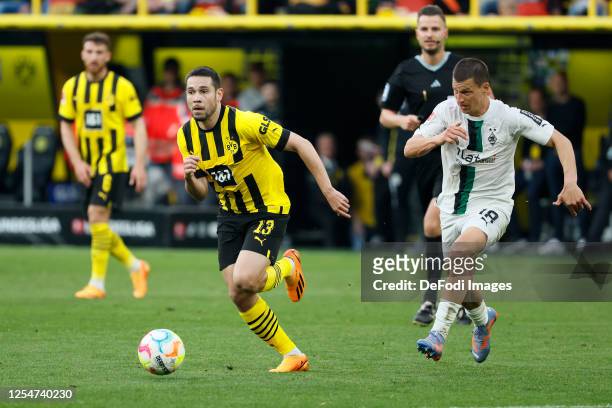 Raphael Guerreiro of Borussia Dortmund and Stefan Lainer of Borussia Moenchengladbach battle for the Ball during the Bundesliga match between...