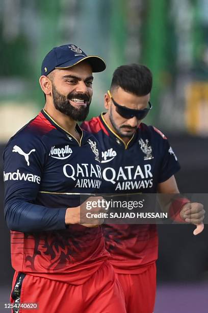 Royal Challengers Bangalore's Virat Kohli celebrates after the dismissal of Rajasthan Royals' Jos Buttler during the Indian Premier League Twenty20...