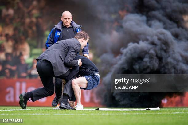Supporter storms the field during the Dutch premier league match between FC Groningen and Ajax at the Euroborg stadium on May 14, 2023 in Groningen,...