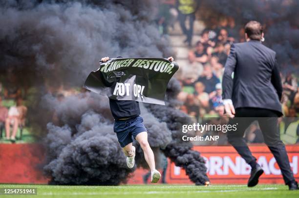 Groningen supporter with a banner "cancer board rotten" during the Dutch premier league match between FC Groningen and Ajax at Euroborg stadium on...