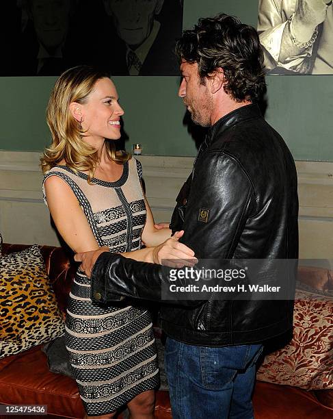 Actors Hilary Swank and Gerard Butler talk at the after party for the Cinema Society screening of "Conviction" at the Soho Grand Hotel on October 12,...